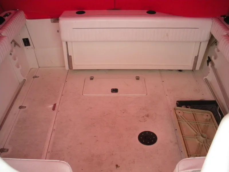 Slide: The Image of 1998 Boston Whaler 23 Conquest boat interior with red accents and storage compartments. - 10