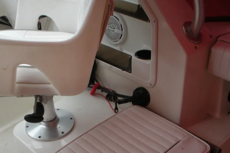 Slide: The Image of Interior of a 1998 Boston Whaler 23 Conquest boat showing seating and speaker. - 11