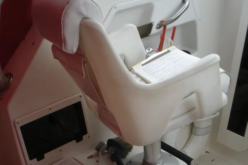 Slide: The Image of Captain's chair on a 1998 Boston Whaler 23 Conquest boat interior. - 12