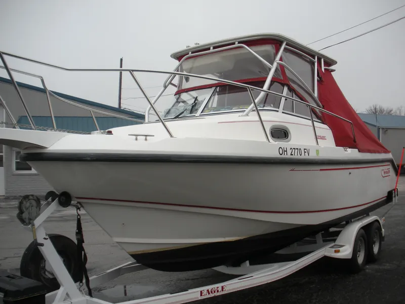 Slide: The Image of 1998 Boston Whaler 23 Conquest boat on trailer with red canopy. - 2