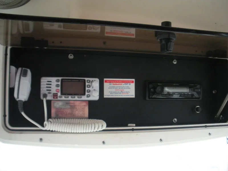 Slide: The Image of 1998 Boston Whaler 23 Conquest dashboard with radio and communication equipment. - 4