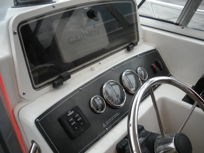 Slide: The Image of 1998 Boston Whaler 23 Conquest dashboard with Garmin navigation system and steering wheel. - 6