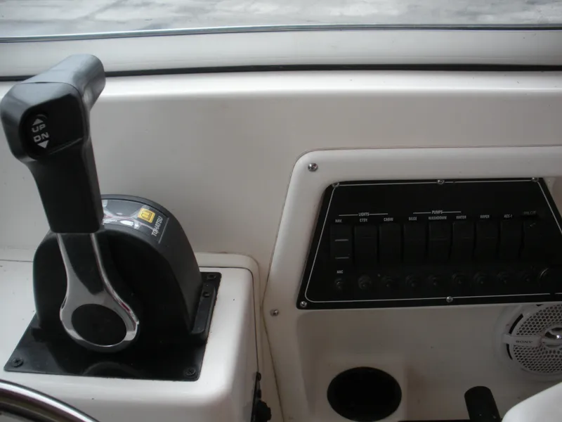 Slide: The Image of Control panel of a 1998 Boston Whaler 23 Conquest boat, featuring throttle and switches. - 8