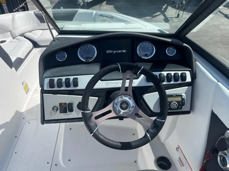 Slide: The Image of Steering wheel and dashboard of a 2018 Bryant Speranza boat, featuring gauges and controls. - 6