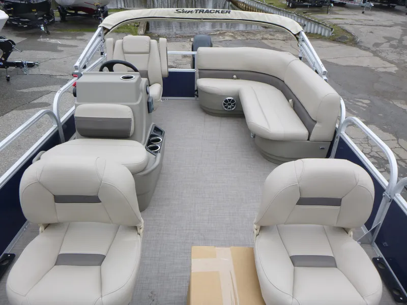 Slide: The Image of 2025 Sun Tracker Bass Buggy 16 XL Select pontoon boat interior with beige seating. - 10