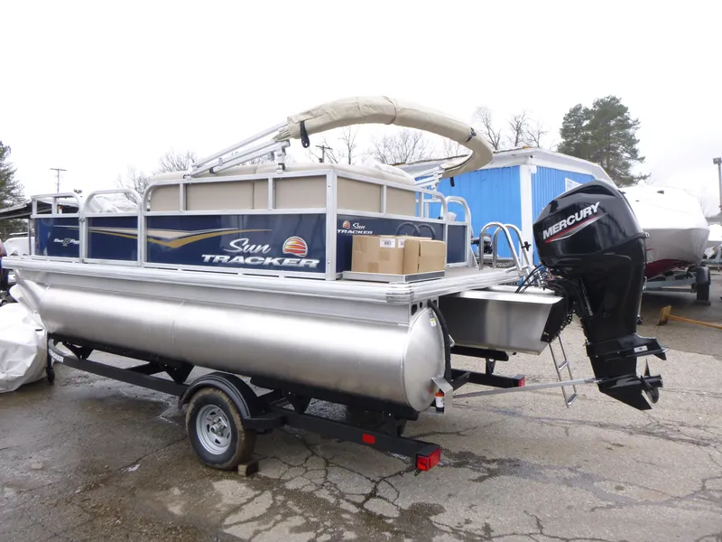 Slide: The Image of 2025 Sun Tracker Bass Buggy 16 XL Select pontoon boat with Mercury outboard motor. - 3