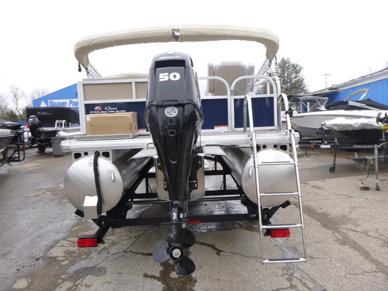Slide: The Image of 2025 Sun Tracker Bass Buggy 16 XL Select pontoon boat with 50 HP engine, rear view. - 4