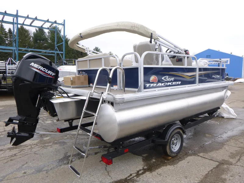 Slide: The Image of 2025 Sun Tracker Bass Buggy 16 XL Select pontoon boat with Mercury outboard motor. - 5