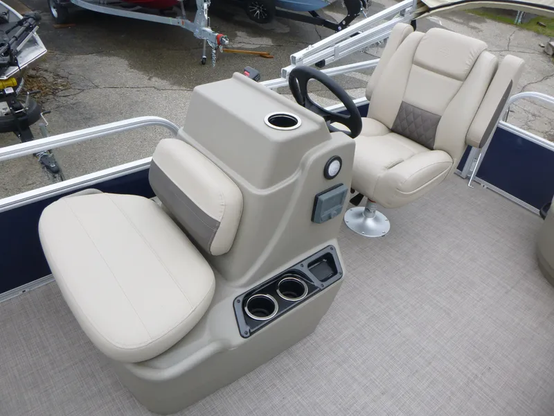 Slide: The Image of 2025 Sun Tracker Bass Buggy 16 XL Select boat interior with beige seating and steering console. - 8