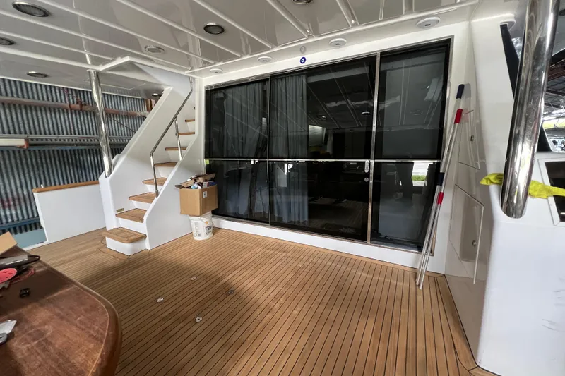 Slide: The Image of Luxurious Falcon 106 yacht interior with wooden flooring and modern staircase, 2001 model. - 10