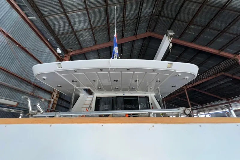 Slide: The Image of Falcon 106 yacht from 2001 in a metal-roofed storage facility. - 12