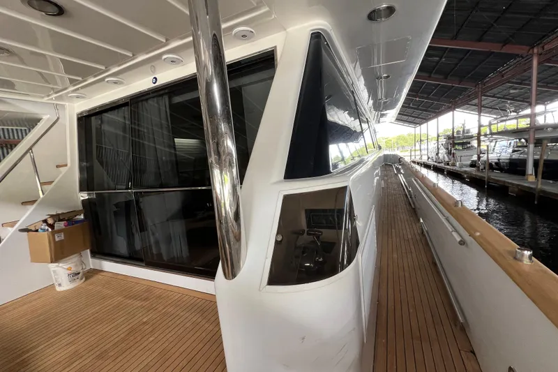 Slide: The Image of Luxurious Falcon 106 yacht from 2001, featuring sleek design and spacious deck area. - 13