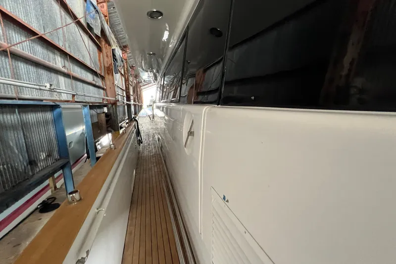 Slide: The Image of Side view of a 2001 Falcon 106 yacht in a shipyard. - 15