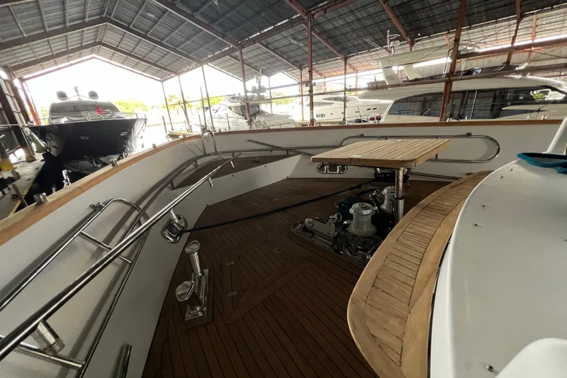 Slide: The Image of Interior view of a 2001 Falcon 106 yacht with wooden deck and metal railings. - 17