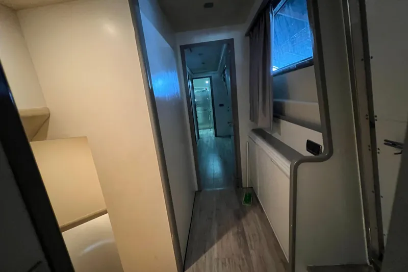 Slide: The Image of Hallway inside a 2001 Falcon 106, featuring modern interior design and lighting. - 21