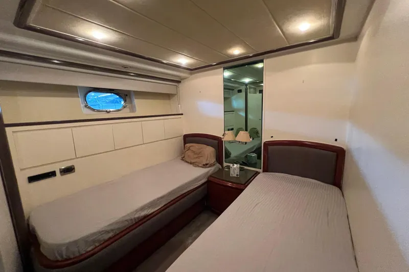 Slide: The Image of Twin cabin interior of 2001 Falcon 106 yacht with modern design and soft lighting. - 24