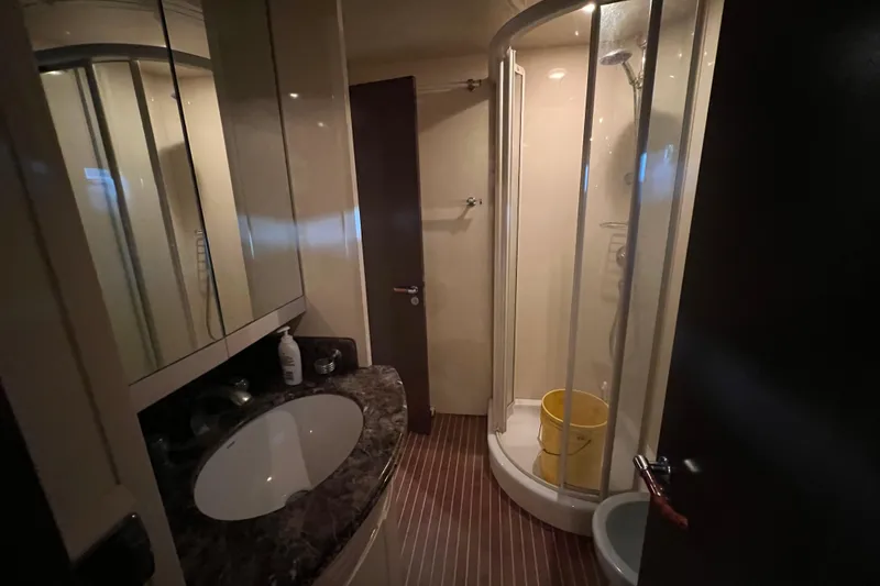 Slide: The Image of Compact bathroom in 2001 Falcon 106 yacht with shower and marble countertop. - 26