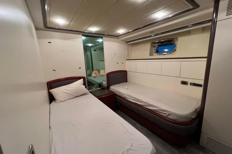 Slide: The Image of Interior of a 2001 Falcon 106 yacht cabin with twin beds and modern decor. - 29