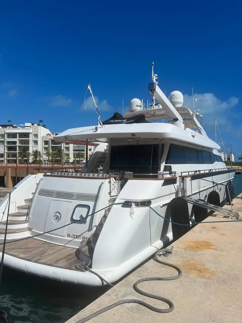 Slide: The Image of Luxury Falcon 106 yacht docked at marina, clear blue sky, 2001 model. - 3
