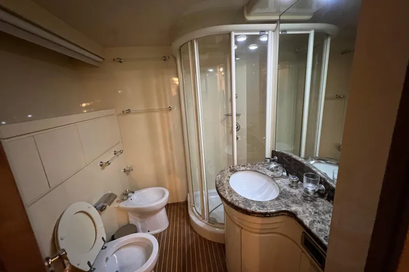 Slide: The Image of Luxurious bathroom in 2001 Falcon 106 yacht with shower, toilet, and marble sink. - 30