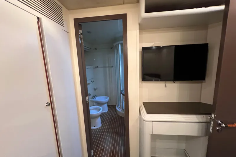 Slide: The Image of Interior of Falcon 106 yacht, featuring a bathroom and wall-mounted TV, 2001 model. - 31