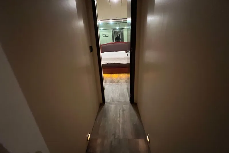 Slide: The Image of Narrow hallway leading to a bedroom on a 2001 Falcon 106 yacht. - 32