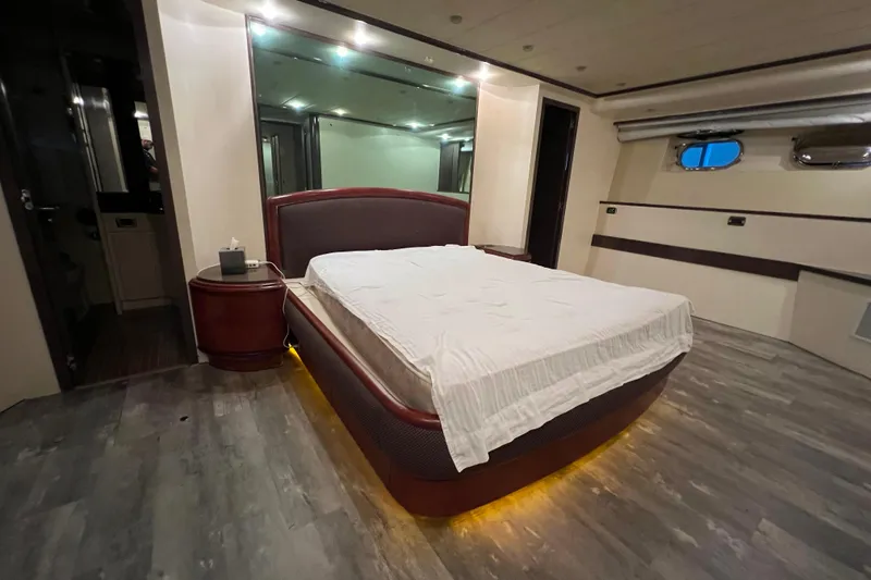 Slide: The Image of Luxurious bedroom interior on a 2001 Falcon 106 yacht, featuring modern design and ambient lighting. - 33