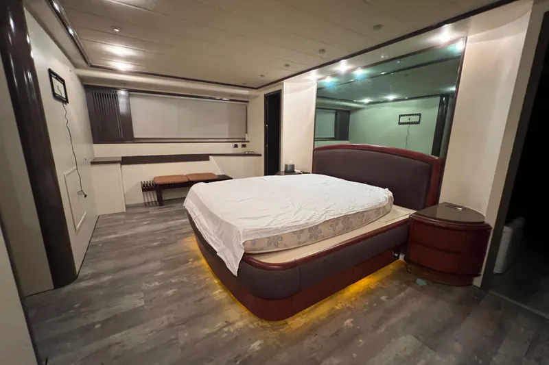 Slide: The Image of Luxurious bedroom interior on Falcon 106 yacht, 2001 model, featuring modern design and ambient lighting. - 34