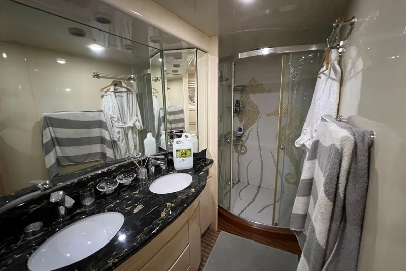 Slide: The Image of Luxurious yacht bathroom with double sinks, glass shower, and elegant decor, Falcon 106, 2001 model. - 35