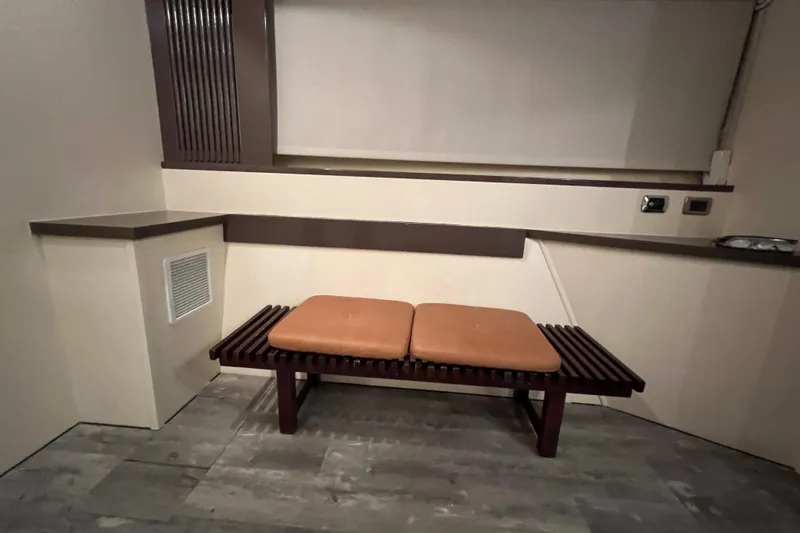 Slide: The Image of Interior of a 2001 Falcon 106 yacht with a cushioned bench and modern design. - 38