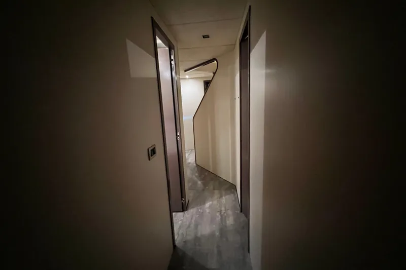 Slide: The Image of Narrow hallway inside a 2001 Falcon 106 yacht, featuring modern design and lighting. - 39