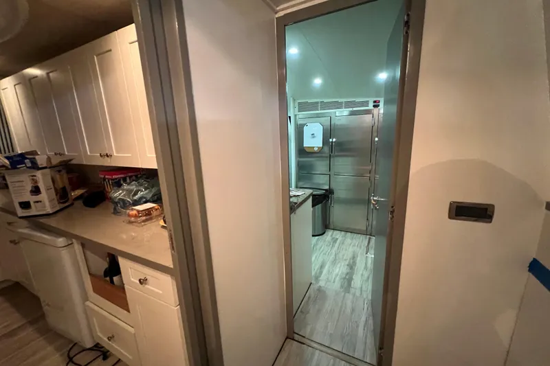 Slide: The Image of Modern kitchen interior in a 2001 Falcon 106, featuring white cabinets and stainless steel appliances. - 41