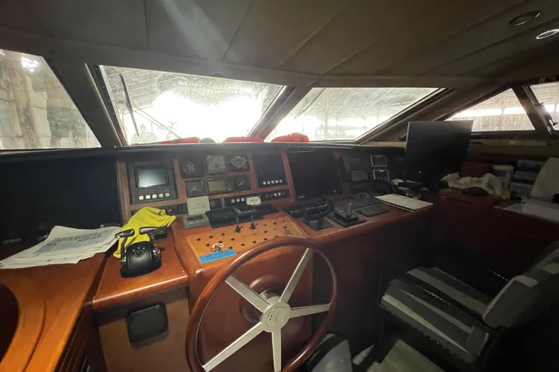 Slide: The Image of Cockpit of 2001 Falcon 106 yacht with navigation controls and steering wheel. - 45