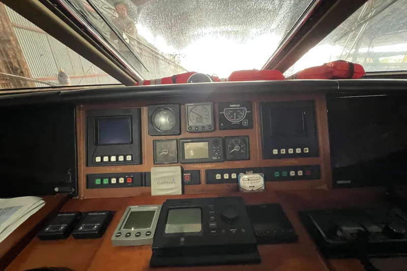 Slide: The Image of Cockpit of a 2001 Falcon 106 yacht with navigation instruments and controls. - 46