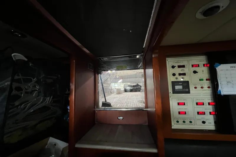 Slide: The Image of Interior of a 2001 Falcon 106 yacht with control panels and a window view. - 49