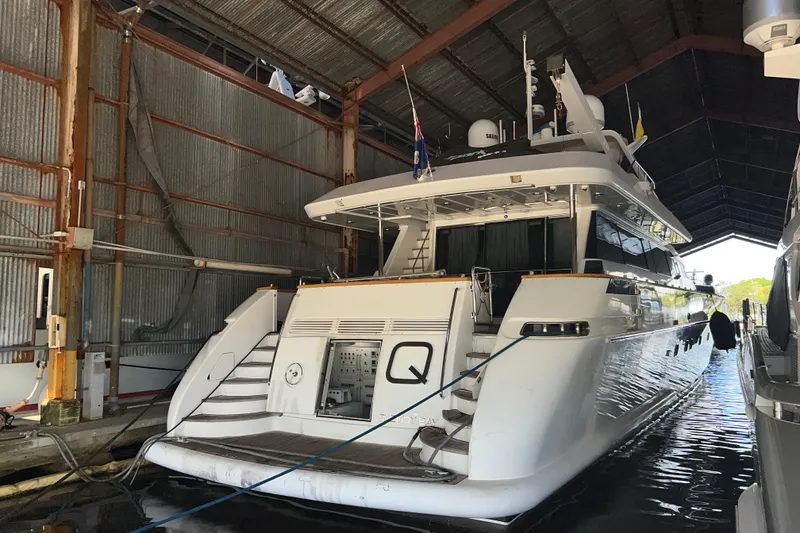 Slide: The Image of Luxury Falcon 106 yacht from 2001 docked in a covered marina. - 5
