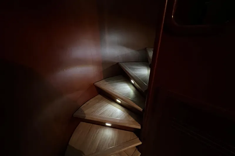 Slide: The Image of Dimly lit wooden spiral staircase on Falcon 106 yacht, 2001 model. - 50