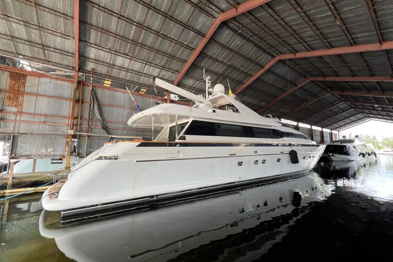Slide: The Image of Luxury Falcon 106 yacht from 2001 docked in a covered marina. - 51
