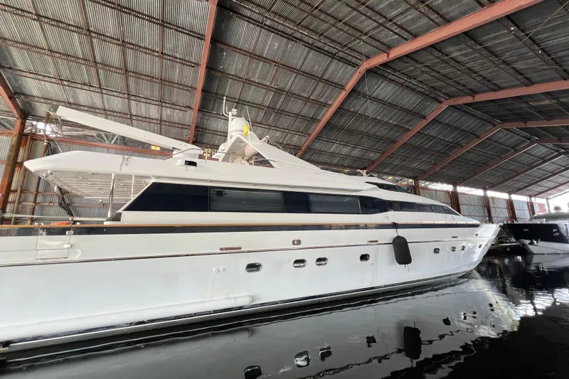 Slide: The Image of Luxury Falcon 106 yacht from 2001 docked in a spacious marina. - 52