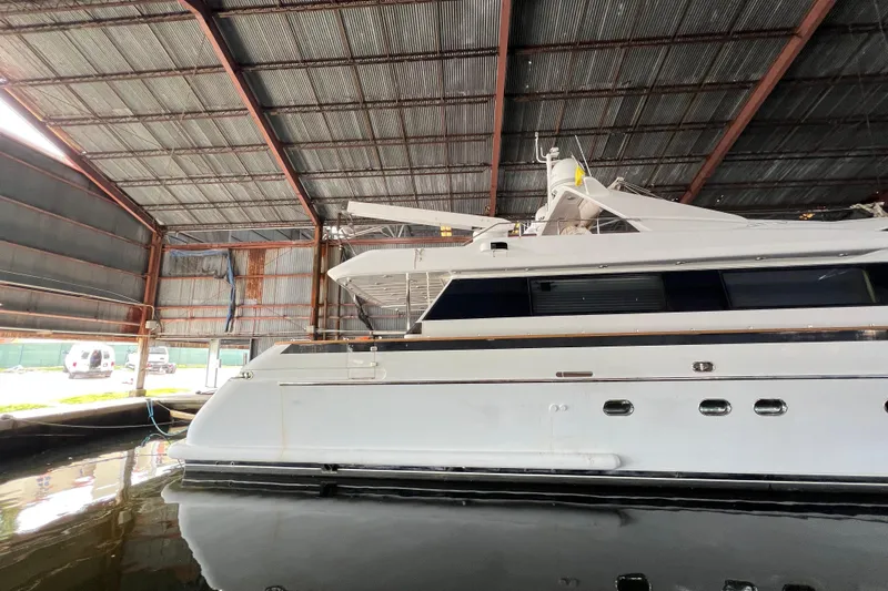 Slide: The Image of Luxury yacht Falcon 106, 2001 model, docked in a covered marina. - 53