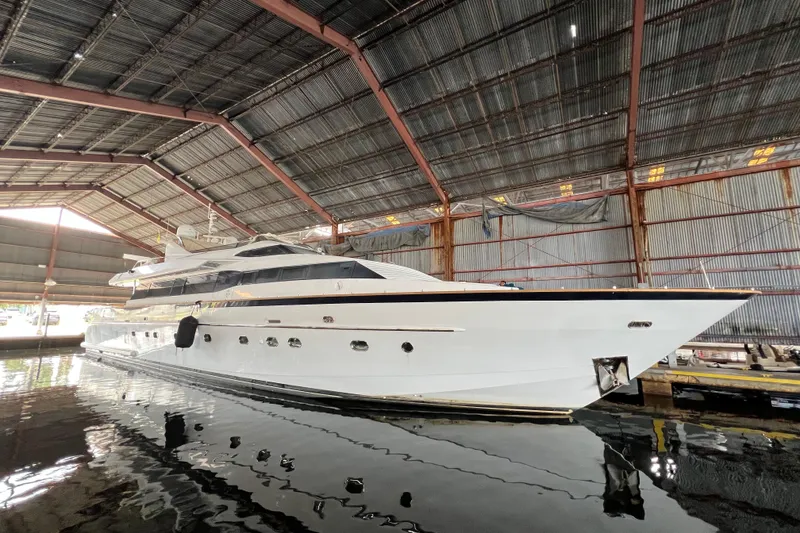 Slide: The Image of Luxury Falcon 106 yacht from 2001 docked in a spacious indoor marina. - 54