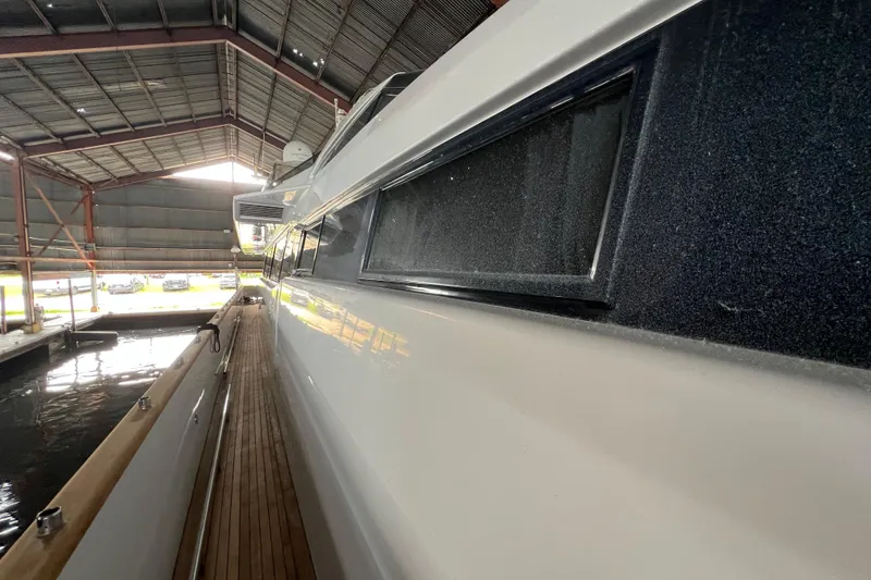 Slide: The Image of Side view of a 2001 Falcon 106 yacht docked in a covered marina. - 7