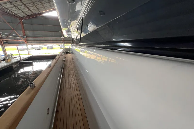 Slide: The Image of Side view of a 2001 Falcon 106 yacht in a covered dock. - 8