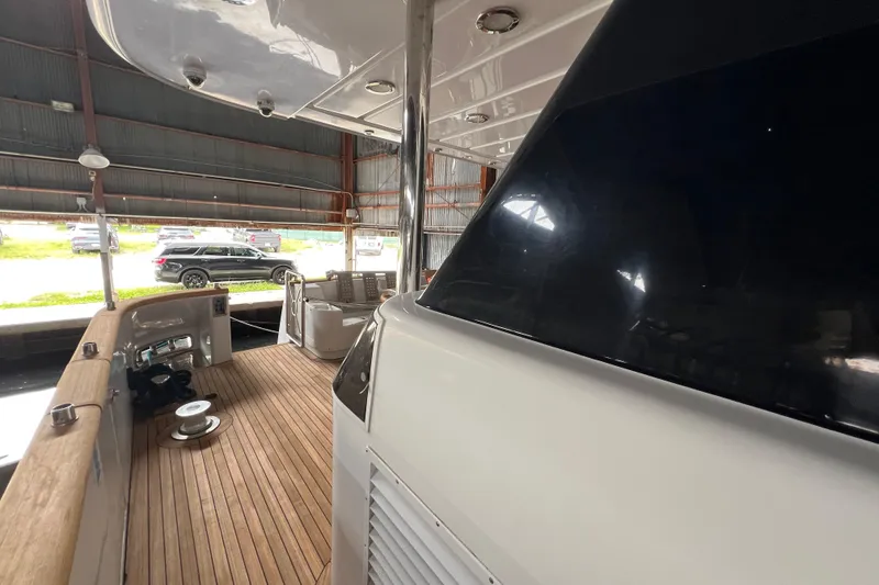 Slide: The Image of Luxurious 2001 Falcon 106 yacht interior with wooden deck and modern design. - 9