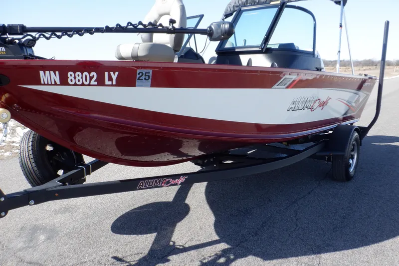 Slide: The Image of 2020 Alumacraft Competitor 165 Sport boat on trailer, red and white design, side view. - 11