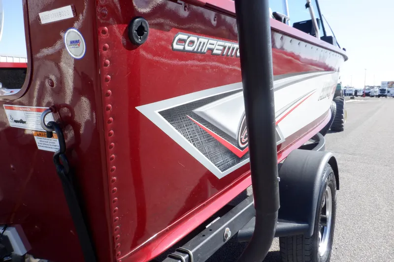 Slide: The Image of 2020 Alumacraft Competitor 165 Sport boat, red exterior with detailed graphics, parked on trailer. - 12