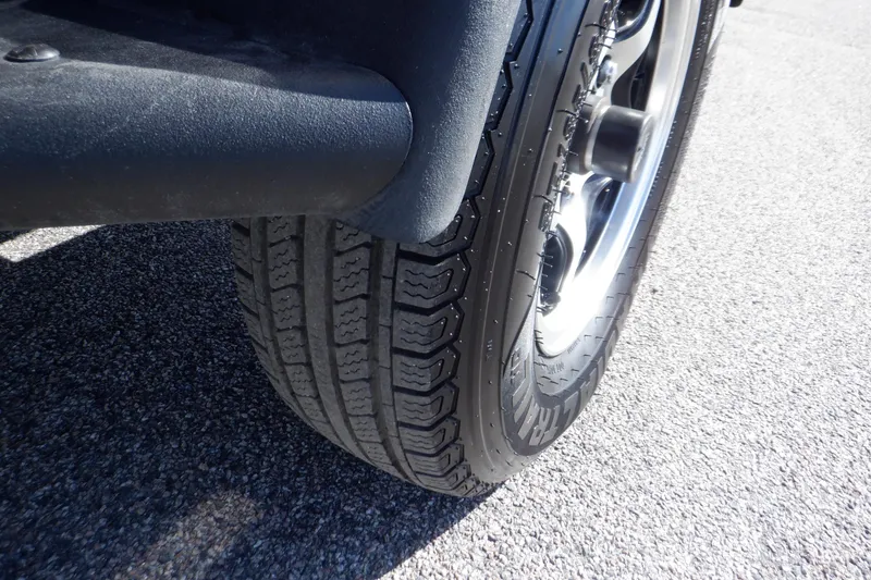 Slide: The Image of Close-up of a tire on a 2020 Alumacraft Competitor 165 Sport boat trailer. - 27