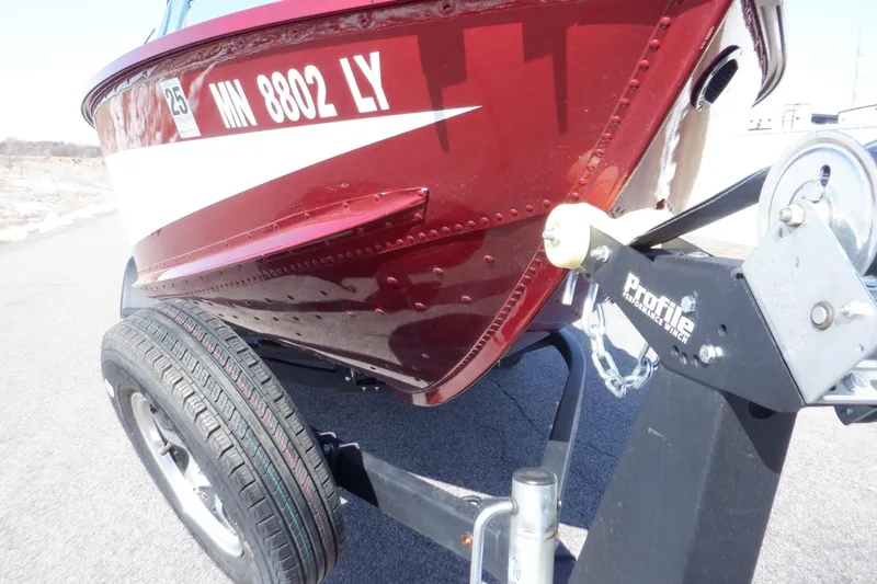 Slide: The Image of 2020 Alumacraft Competitor 165 Sport boat on trailer, close-up of hull and registration. - 34