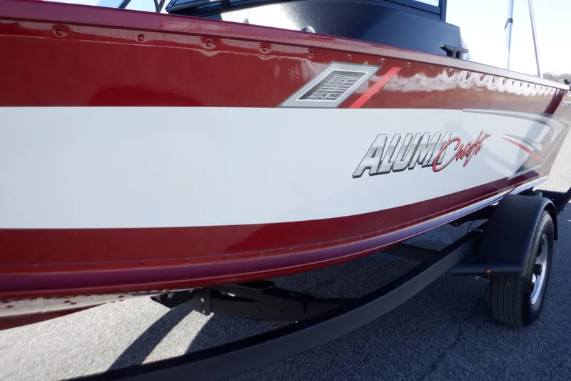Slide: The Image of 2020 Alumacraft Competitor 165 Sport boat, red and white exterior, on a trailer. - 36