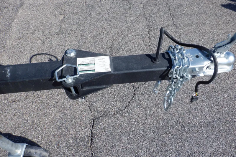 Slide: The Image of Trailer hitch of 2020 Alumacraft Competitor 165 Sport with safety chains on asphalt. - 39